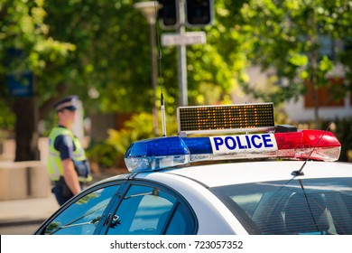 South Australian Police Car On Street In Adelaide With Policeman On Background