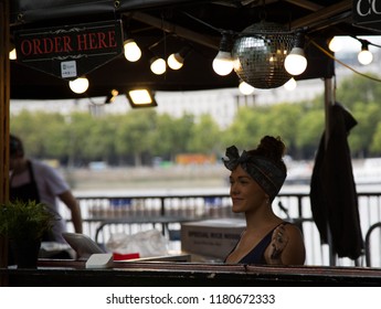 South Bank, London, UK, Sept 2018. Retro Dressed Lady In 50's Fashion Serving At Food Counter, Smiling.