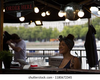 South Bank, London, UK, Sept 2018. Retro Dressed Lady In 50's Fashion Serving At Food Counter, Smiling.