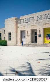 South Beach, Florida - May 5, 2022: Woman In Blue Dress Entering The Bass Museum Of Contemporary Art