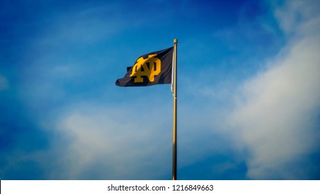 South Bend, Indiana / USA - October 30 2018: Blue And Gold ND Notre Dame Fighting Irish Logo Flag Flies In Wind Over Stadium