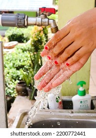 
South Borneo, Indonesia - September 2022: A Woman Washes Her Hands In The Sink On A Blurred Background