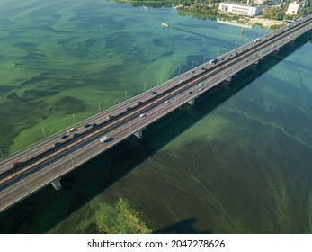 South Bridge In Kiev. Algae Bloom In The Water Of The Dnieper River. Aerial Drone View.