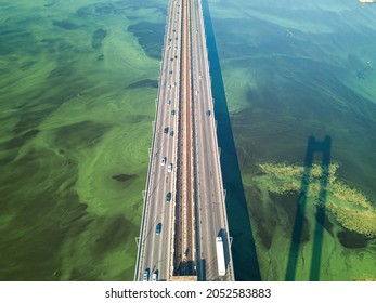 South Bridge In Kiev. Algae Bloom In The Water Of The Dnieper River. Aerial Drone View.