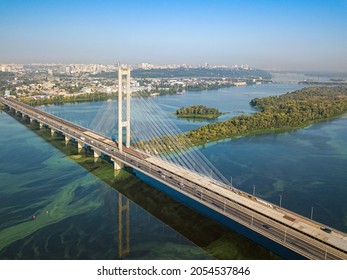 South Bridge In Kiev. Algae Bloom In The Water Of The Dnieper River. Aerial Drone View.