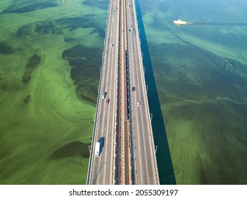 South Bridge In Kiev. Algae Bloom In The Water Of The Dnieper River. Aerial Drone View.