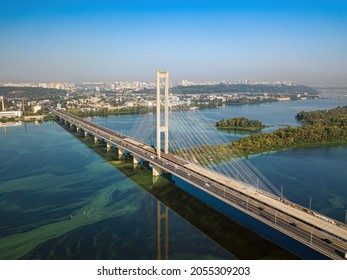 South Bridge In Kiev. Algae Bloom In The Water Of The Dnieper River. Aerial Drone View.