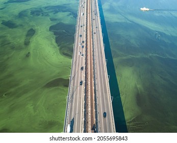 South Bridge In Kiev. Algae Bloom In The Water Of The Dnieper River. Aerial Drone View.