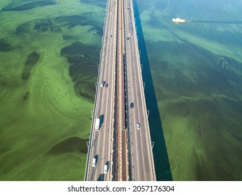 South Bridge In Kiev. Algae Bloom In The Water Of The Dnieper River. Aerial Drone View.