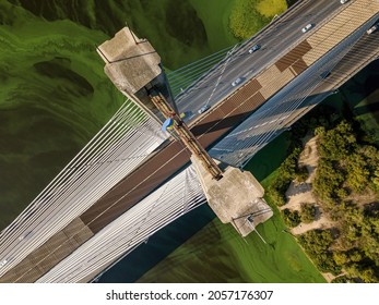 South Bridge In Kiev. Algae Bloom In The Water Of The Dnieper River. Aerial Drone View.