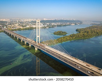 South Bridge In Kiev. Algae Bloom In The Water Of The Dnieper River. Aerial Drone View.