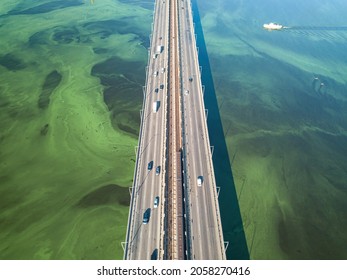 South Bridge In Kiev. Algae Bloom In The Water Of The Dnieper River. Aerial Drone View.