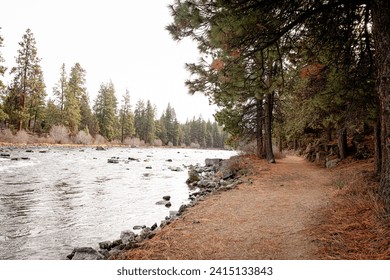 South Canyon Reach of Deschutes River Trail in Bend, Oregon. A popular hiking and running trail along a river in Bend, a town in Cascade Mountains - Powered by Shutterstock