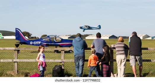 South Cerney Airfield, Gloucestshire Sept 2018. Vintage Fair. Group Of People Watching Vintage Plane Take Of With Aircraft In Background Off The Ground. 