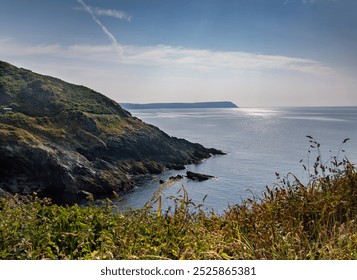 South cornwall coast cliffs and English channel, Blue sky and deep blue sea. Rocky coastline. Light clouds - Powered by Shutterstock