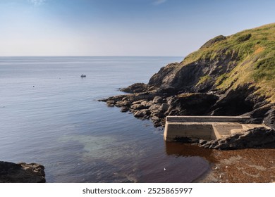 South cornwall coast cliffs and English channel, Blue sky and deep blue sea. Rocky coastline. Concrete sea wall - Powered by Shutterstock