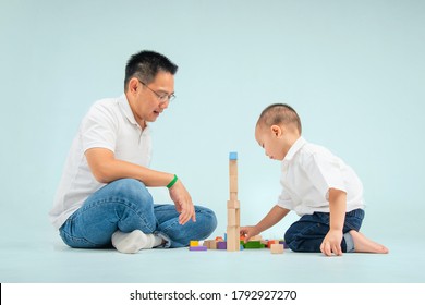 South East Asian Father Playing Toy With His Toddler Son