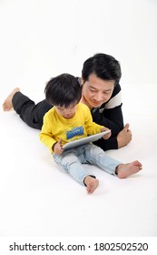 South East Asian Father Son Child Playing Talking With Tablet Pc Tab On White Background