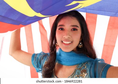 South East Asian Indian Race Ethnic Origin Woman Wearing Indian Dress Costume Salwar Kameez Multiracial Community Holding Under Malaysian Flag Jalur Gemilang On White Background