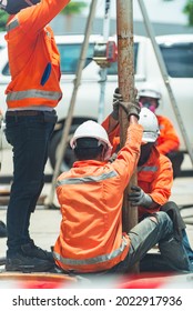 South East Asian, People, Technicians Clean Up Oil Spill And Repairs Damaged Fuel Pump.