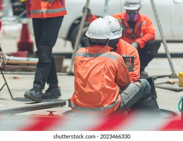 South East Asian, People, Technicians Clean Up Oil Spill And Repairs Damaged Fuel Pump.