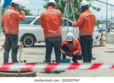 South East Asian, People, Technicians Clean Up Oil Spill And Repairs Damaged Fuel Pump.