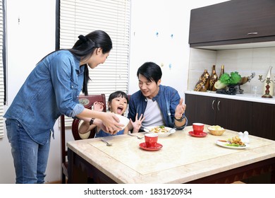 South East Asian Yong Family Daughter Child Parent Father Mother At Dining Table Eating Food Lunch