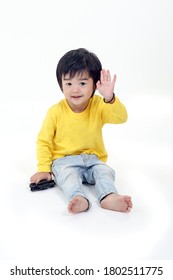 South East Asian Young Boy Child Playing Happy Waving Hand At Camera On White Background