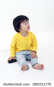 South East Asian Young Boy Child Playing Looking Up On White Background