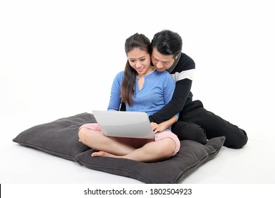 South East Asian Young Chinese Couple Husband Wife On Floor Using Laptop Computer White Background