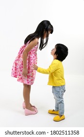 South East Asian Young Girl Boy Child Brother Sister Siblings Playing Happy Talking On White Background