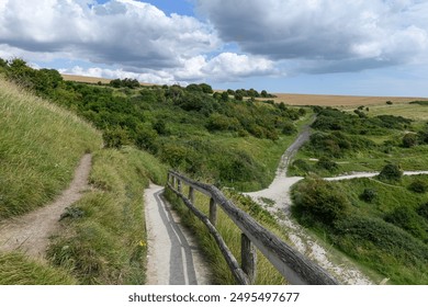 South Foreland Heritage Coast, Dover, England,  A scenic path winding through lush green hills and fields under a partly cloudy sky, showcasing the natural beauty and tranquility of the South Foreland - Powered by Shutterstock