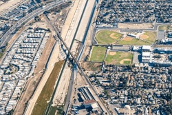 South Gate, California, USA - Aerial View Of The Old South Gate Train Bridge, The Los Angeles River, Legacy High School And Suburban South Gate, California Near The Thunderbird Mobile Home Park