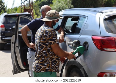 South Government-tyre City-Lebanon:14-8-2021
A Person Is Filling Petrol For One Of The Cars Waiting In Line At Gas Stations In Lebanon 