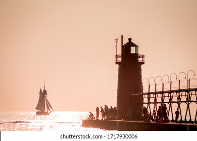 South Haven, MI /USA - September  16th 2017:  Lighthouse And Tall Ship At Sunset