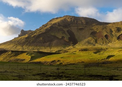 South Iceland mountain landscape in Vík í Mýrdal villages area with volcanic mountain ridge covered with moss and landslides, sunset view. - Powered by Shutterstock