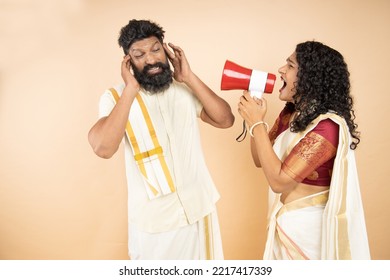 South indian wife scream or shouting at husband in megaphone isolated on beige background. announce discounts sale. Mental health. Relationship difficulty, Couple fighting. Hurry up. Marriage problems - Powered by Shutterstock