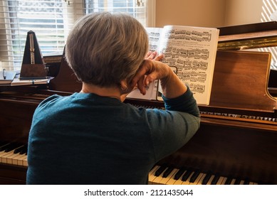 South Jordan, Utah, USA - Feb. 10, 2022.  Teaching A 'virtual' Piano Lesson.  Learning To Play The Piano Requires Patience And Commitment.  Virtual Lessons Using Facetime Adds Another Level Of Stress.