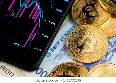 South Korea Won Banknotes and Bitcoin Cryptocurrency coins. Asia Bitcoin