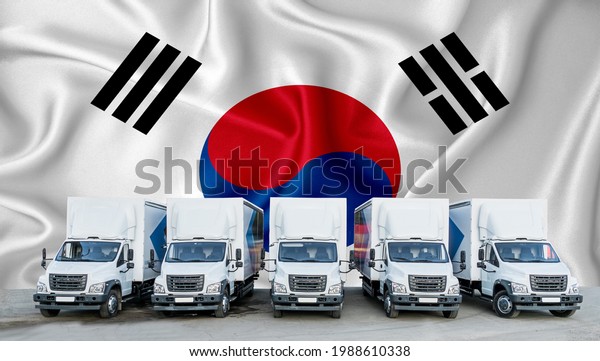 South Korean flag in the background.\
Five new white trucks are parked in the parking lot. Truck,\
transport, freight transport. Freight and logistics\
concept