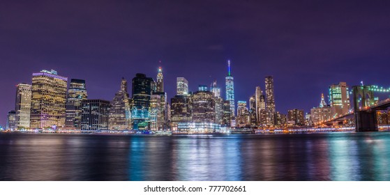 South Manhattan And Financial District View From Brooklyn At Night In New York City With Urban Skyscrapers.