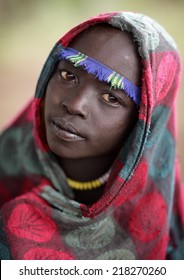 SOUTH OMO - ETHIOPIA - July 23, 2014: Unidentified Mursi boy on July 23, 2014 in South Omo, Ethiopia. A 5-year ongoing resettlement program started 2011 threatens the tribes in Ethiopia. - Shutterstock ID 218270260
