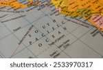 South Pacific Ocean region, location or territory mark drawing on a map with some famous country names words or text written on the surface. Closeup top view. Sea adventure navigation concept.