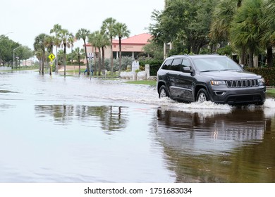 South Pasadena, Florida / USA - June 7 2020: Cars Navigate Flooded Streets In The Tampa Bay Region From Tropical Storm Cristobal.