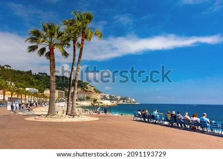 South sidewalk witn blue chairs of Promenade des Anglais in Nice, French Riviera, France