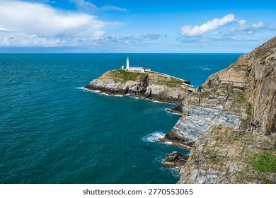 South Stack Lighthouse on Holy Island near Holyhead, Anglesey, Wales, standing on a rocky sea stack with dramatic cliffs and views across the Irish Sea along the rugged Welsh coastline.