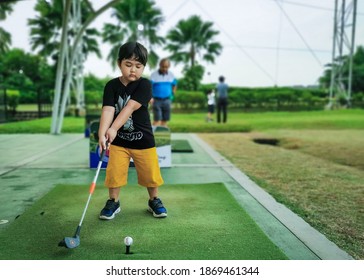 South Tangerang, Indonesia - November 9, 2020: Kid Golf Backswing Take Off Position At Golf Driving Range