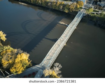 South Washington Street Parabolic Bridge in Binghamton New York (aerial view, from above, looking down at the Susquehanna river) autumn, colorful leaves, foliage, downtown pedestrian walkway