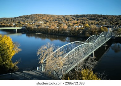 South Washington Street Parabolic Bridge in Binghamton New York (aerial view, from above, looking down at the Susquehanna river) autumn, colorful leaves, foliage, downtown pedestrian walkway