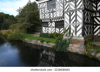 South Wing Of A Tudor Manor House Reflected In The Moat